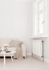 Mock up wall with beige white sofa, two tables and a chair in modern interior background, living room with large window an radiator, Scandinavian style, 3D render, 3D illustration