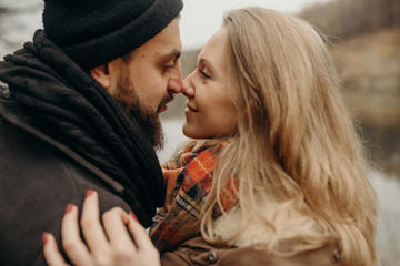 Adventure time. Outdoor happy couple in love posing in cold weather. Young boy and girl having fun outdoor