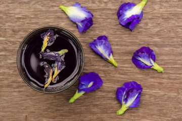 Butterfly pea juice and butterfly pea flower on wood background