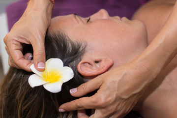 Obraz na płótnie Canvas Beautiful young woman enjoying massage in spa salon