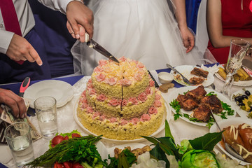 the bride and groom cut the wedding cake.