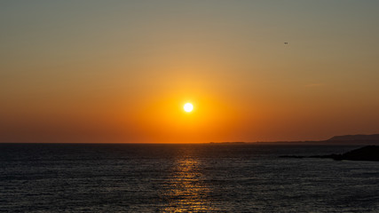 Obraz premium orange greek sunset on beach