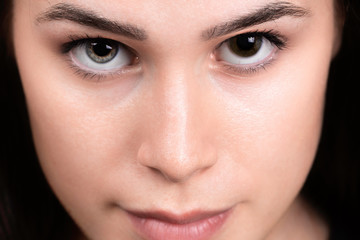 face close up of a girl with Heterochromia iridum in her eyes, difference in coloration in human iris of the eyes