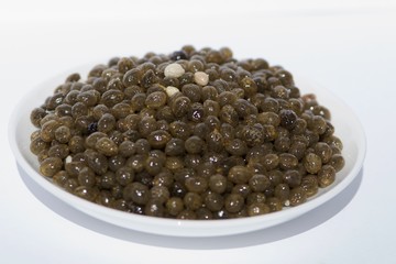 papaya seeds on white saucer