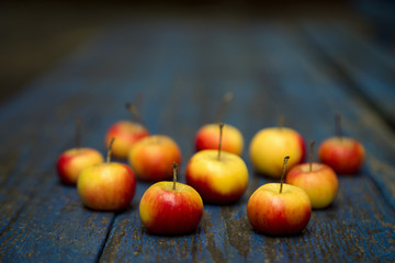 Apple, natural non-GMO, without chemistry, with a child's hand, on a wooden old background