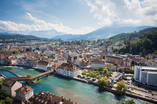 Beautiful picture of river through the town Luzern in Switzerland and mountaing Pilatus on the background