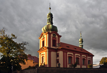 All Saints church in Europe in Prague. Roman catholic parish with a statue of Jesus on the cross at the tree.