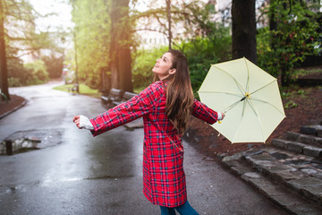 Portrait of a beautiful woman walking with an umbrella.