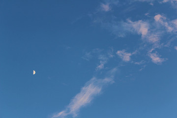 blue sky with clouds and moon