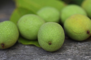 Walnuts plucked from a tree in a green shell. Harvest of walnuts. Selective focus. Macro.