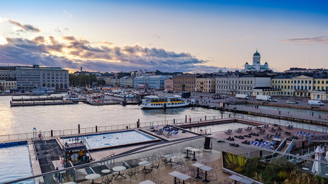 Helsinki. Finland. Embankment of the city of Helsenki. Pool with views of the promenade. St. Nicholas Cathedral. Suurkirkko. Harbor in the city. Embankment of Finland against the blue sky.