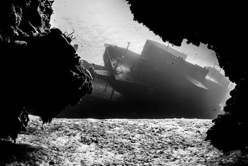  shot taken of the USS Kittiwake. The sunken shipwreck in this angle has been captured from underneath the nearby reef to create a cool framing effect.