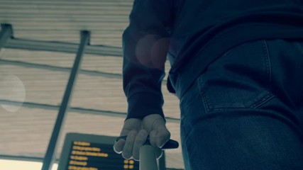 Departure board displaying train information.Beautiful motion blur with  running people at train station.