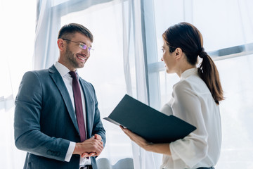 Fototapeta premium back view of journalist talking with businessman in formal wear