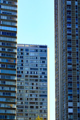 Skyscraper dwelling in the city. Many windows and balconies.