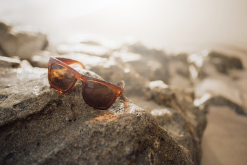 Sunglassed on the beach and stone