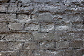Old brick wall painted black.