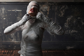 mummy screams in horror and tears the bandages. The girl with the bandage.
