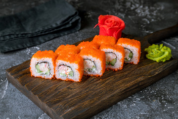 California roll with crab on the board on grey concrete table