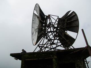 A Guy Sitting Atop an Abandoned Communication Station