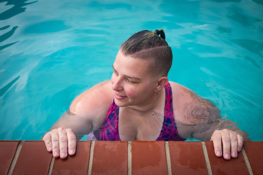 Non-binary queer person in pool