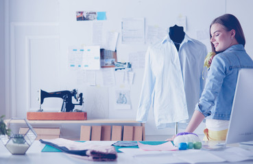 Fashion designer working on her designs in the studio