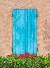 Pretty blue wooden shutters on an old house in rural Provence. 