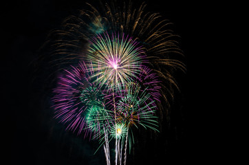 colorful fireworks on the black sky background with free space for text. Celebration and anniversary concept