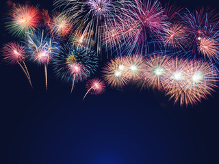 Fototapeta premium colorful fireworks on the black sky background with free space for text. Celebration and anniversary concept