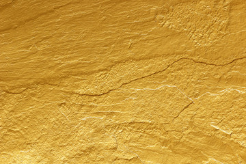gold paint stone texture glitter abstract background.