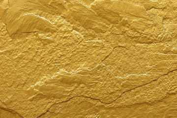 gold paint stone texture glitter abstract background.
