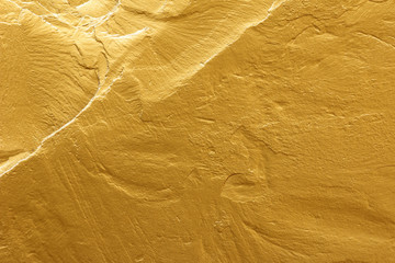 gold paint stone texture glitter abstract background.