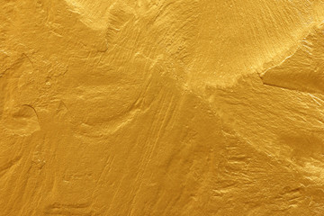 gold paint stone texture glitter abstract background.