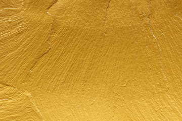 gold paint stone texture glitter abstract background.