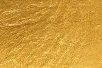 gold paint stone texture glitter abstract background.