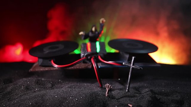 Happy Halloween horror party concept. Scary view of dancing zombies at cemetery with Dj and club lights. Creative artwork decoration. Useful as a party poster or greeting card. Selective focus