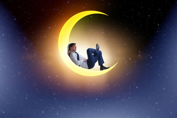Obraz na płótnie Canvas Businessman sitting on the crescent moon