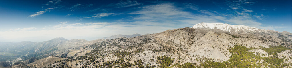 Panoramic view of mountains against sky with snowcapped mountain in background