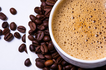 Cup Of Coffee With Roasted Coffee Beans Isolated On White