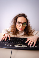 Funny nerd girl working on computer