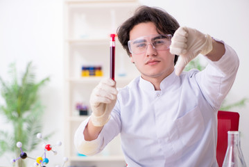 Young male biochemist working in the lab