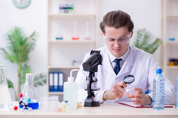 Young male chemist experimenting in lab