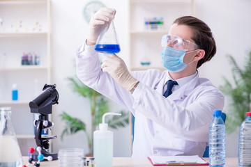 Young male chemist experimenting in lab