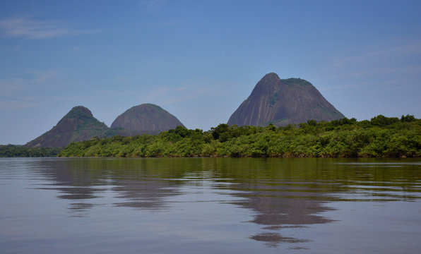 The Guainía river and the Cerros de Mavicure. Three hills, located in Colombia.The three mountains, Pajarito (Little Bird), Mono (Monkey) and Mavicure