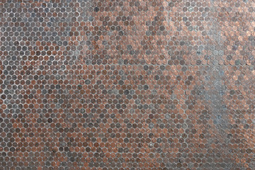 Hundreds of American copper pennies are shown as a flat wall background.