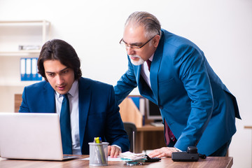 Young and old employees working together in the office