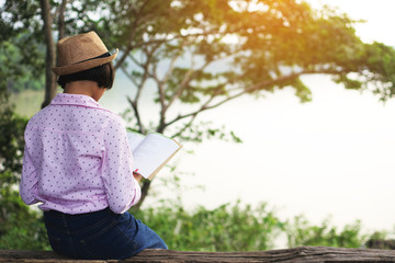 A hobby time asian girl reading a book .