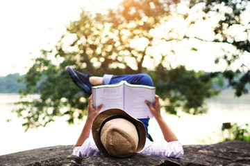 A hobby time asian girl reading a book .