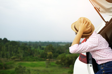 Asian girl traveling with a car on holiday.