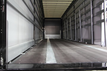 New truck empty semi trailer inside rear view close-up, lorry transportation logistics